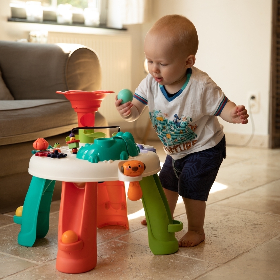 Kid playing with learn & discovery table